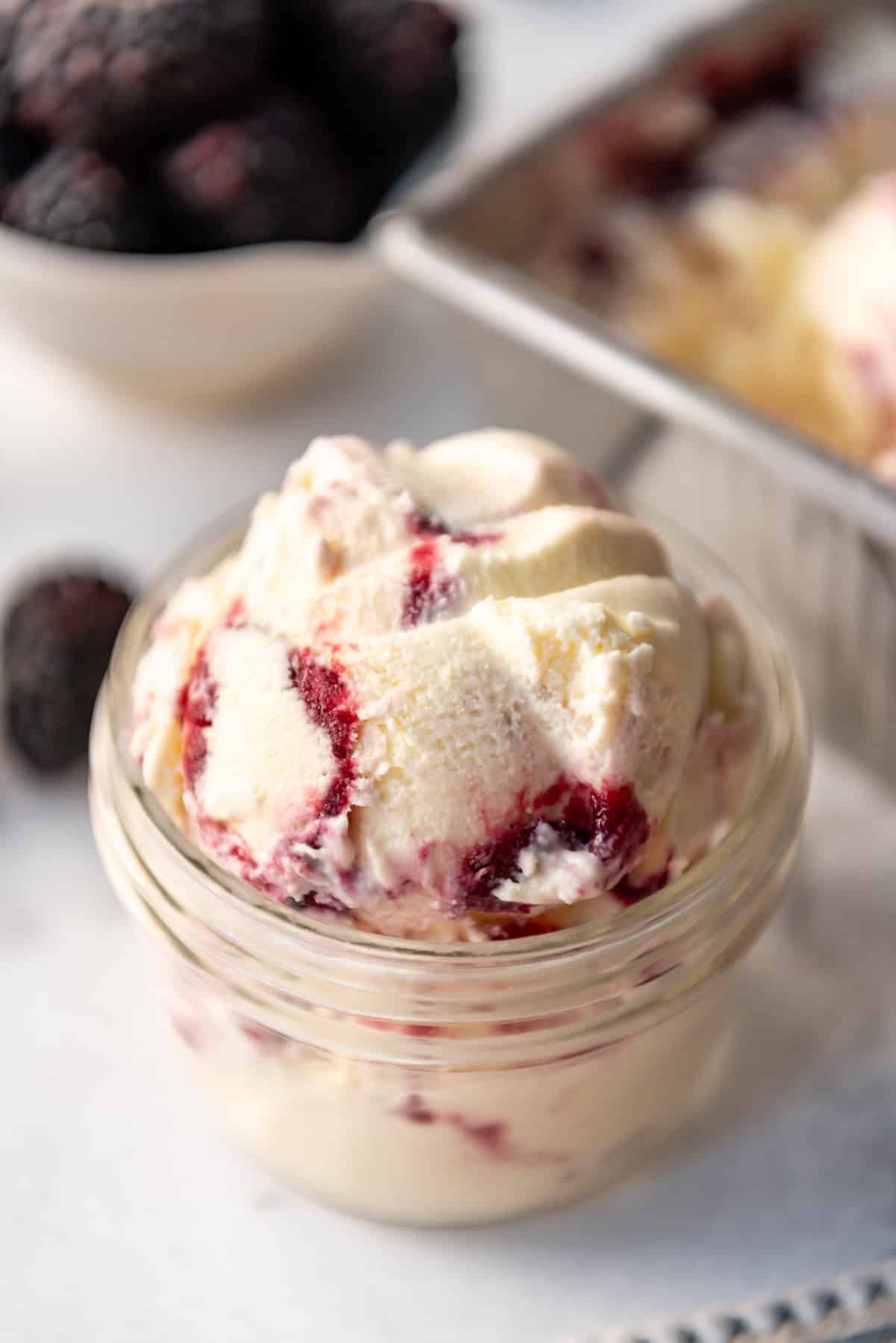 A scoop of homemade blackberry swirl ice cream in a bowl.