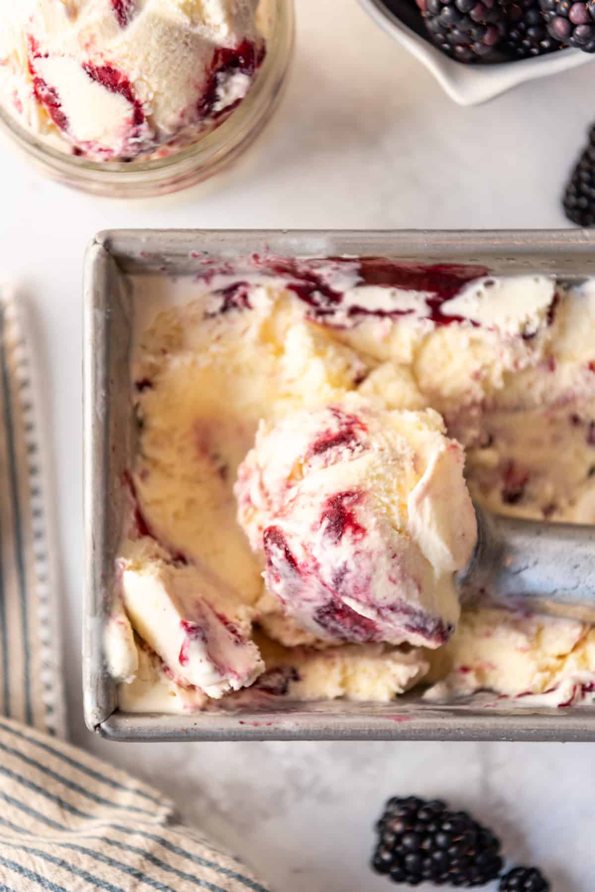 An overhead image of a scoop of blackberry swirl ice cream.