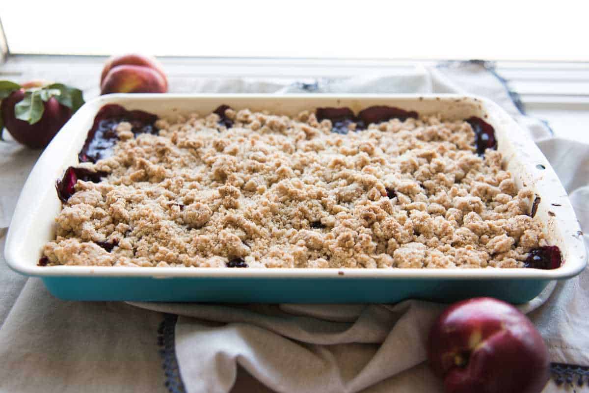 An image of a fruit crumble made with nectarines and blackberries.