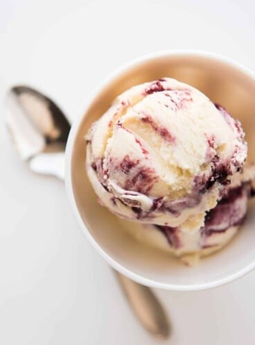 A scoop of blackberry swirl ice cream in a bowl.