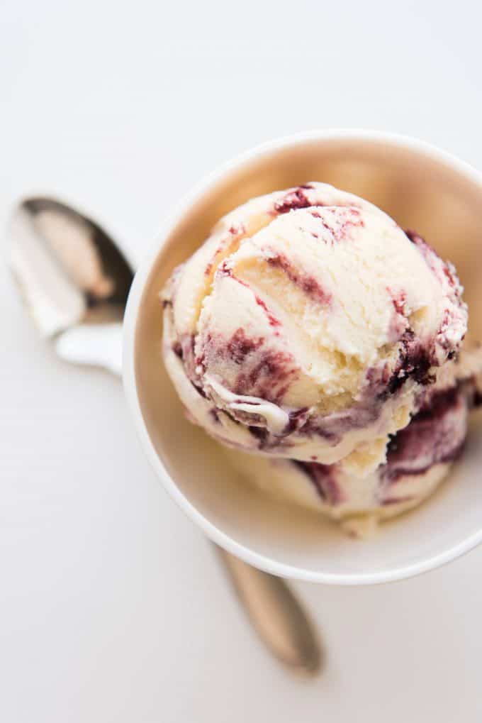 A scoop of homemade blackberry swirl ice cream in a bowl.
