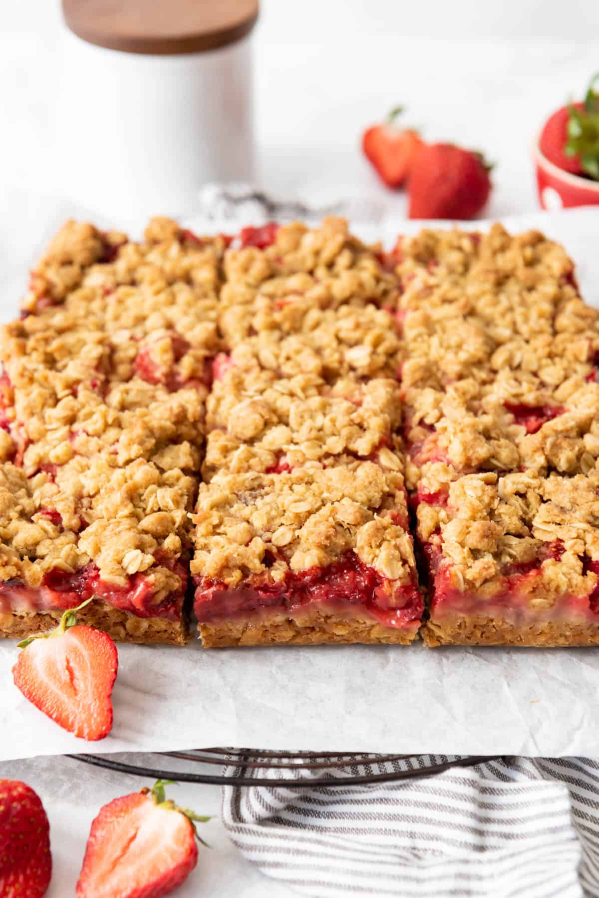 Strawberry rhubarb crumb bars cut into squares.