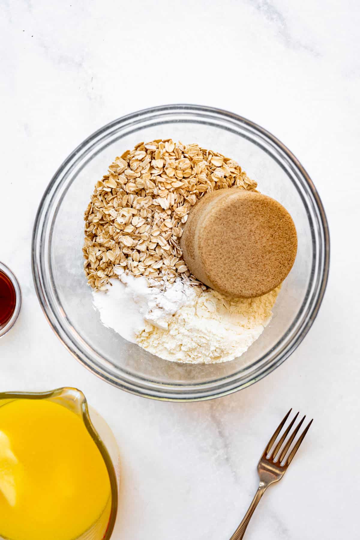 Combining brown sugar, old-fashioned oats, and flour in a large mixing bowl.