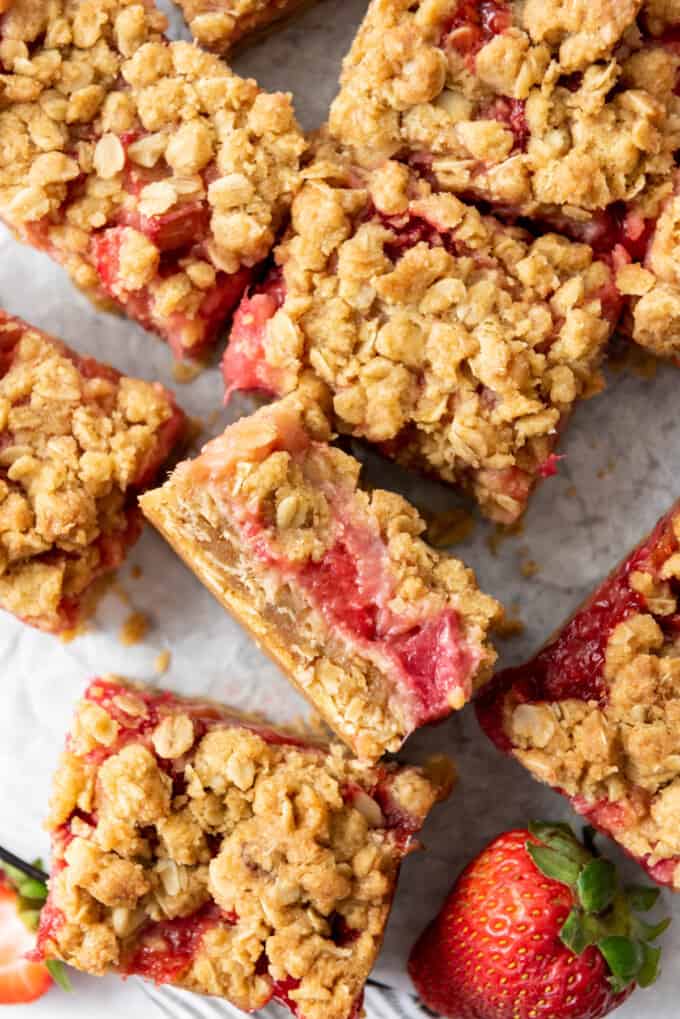 Strawberry rhubarb crumb bars with one turned on its side to showcase the jammy fruit filling.