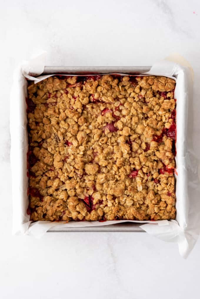 Baked strawberry rhubarb crumb bars cooling in the pan.