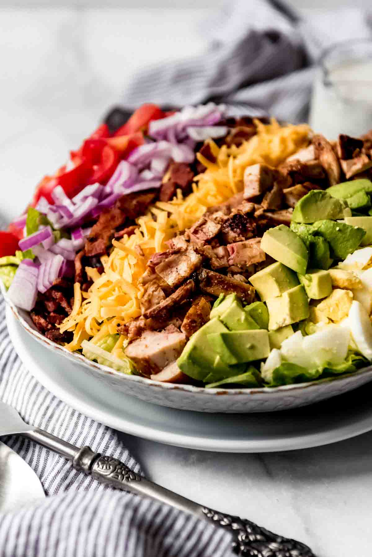 A side view of a grilled chicken cobb salad.