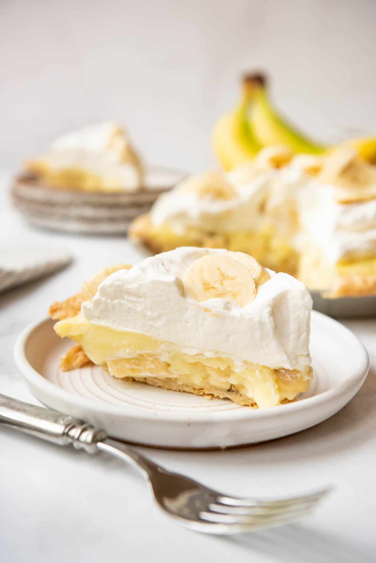 A slice of homemade banana cream pie on a plate.