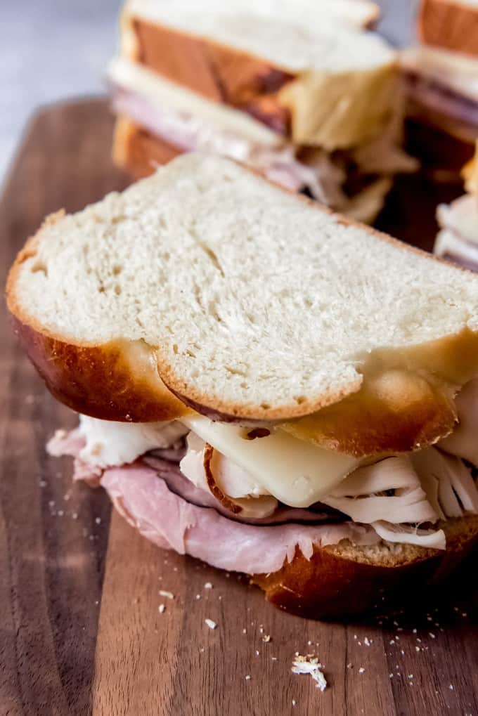 An image of ham, swiss cheese, and turkey on challah bread.