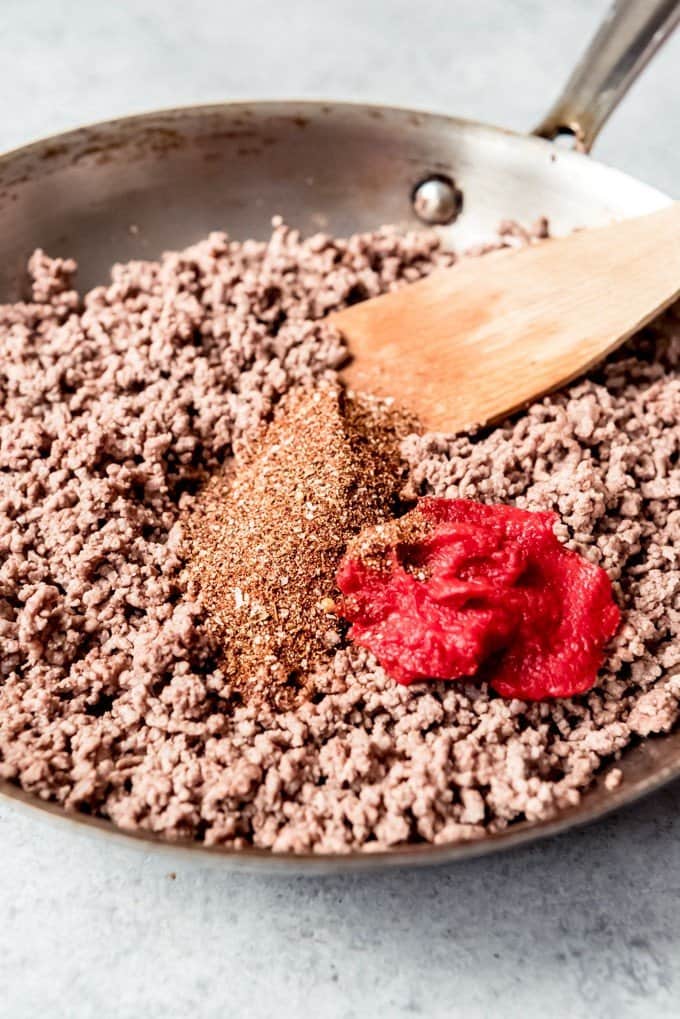 An image of a pan of browned ground beef with homemade taco seasoning and tomato paste.