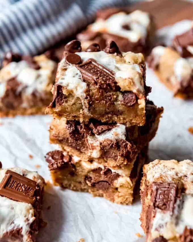 An image of s'mores bars cut into squares and stacked on top of each other.