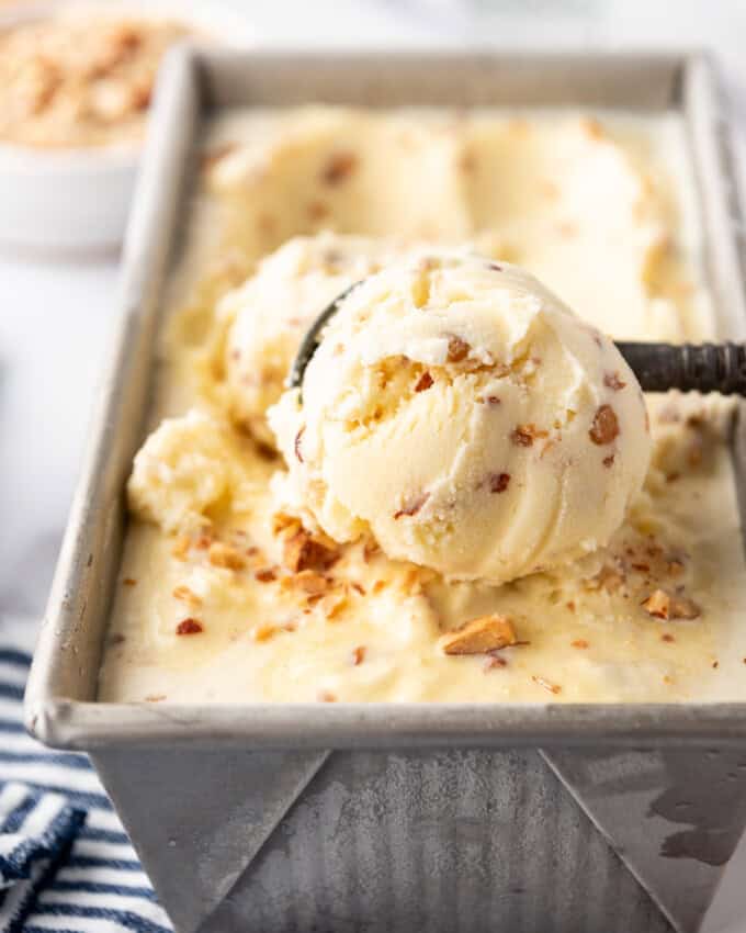 A big scoop of toasted almond ice cream in a loaf pan.