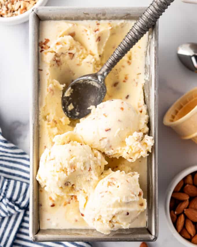 An overhead image of homemade toasted almond ice cream in a pan.