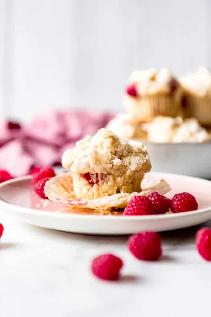 An image of a homemade raspberry muffin on a plate.