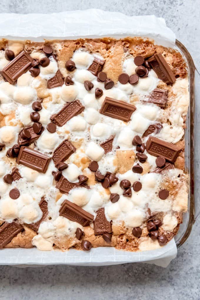 An image of s'mores cookie bars in a pan lined with parchment paper for easy removal.