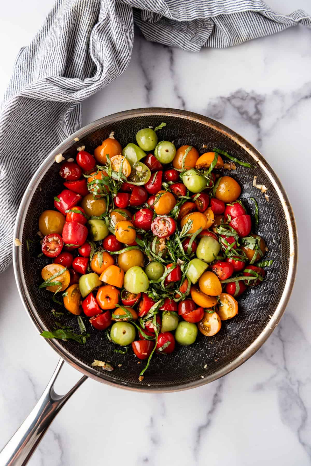 An overhead image of a tomato basil salad in a pan.