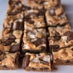 S'mores Bars are everybody's favorite campfire treat except in bar form and without the camping! Gooey marshmallows, buttery graham cracker crust, and melty chocolate, all in a wonderful cookie bar that you won't be able to stop eating!