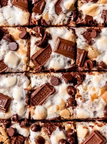 An image of s'mores bars topped with Hershey's chocolate squares and toasted marshmallows.