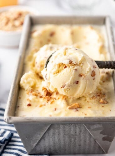 A big scoop of toasted almond ice cream in a loaf pan.