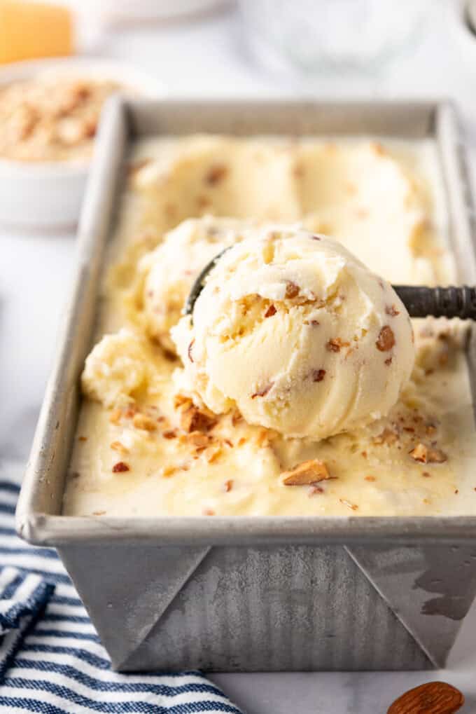 A big scoop of toasted almond ice cream in a loaf pan.