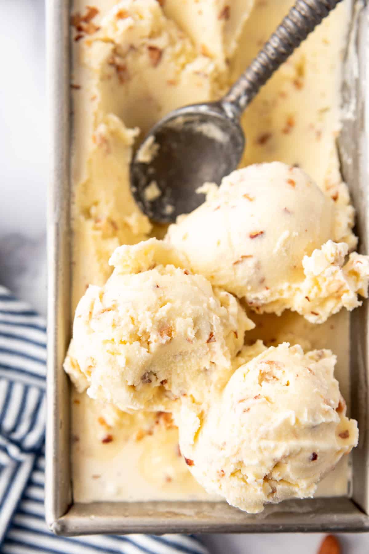 A close up image of scoops of toasted almond ice cream.