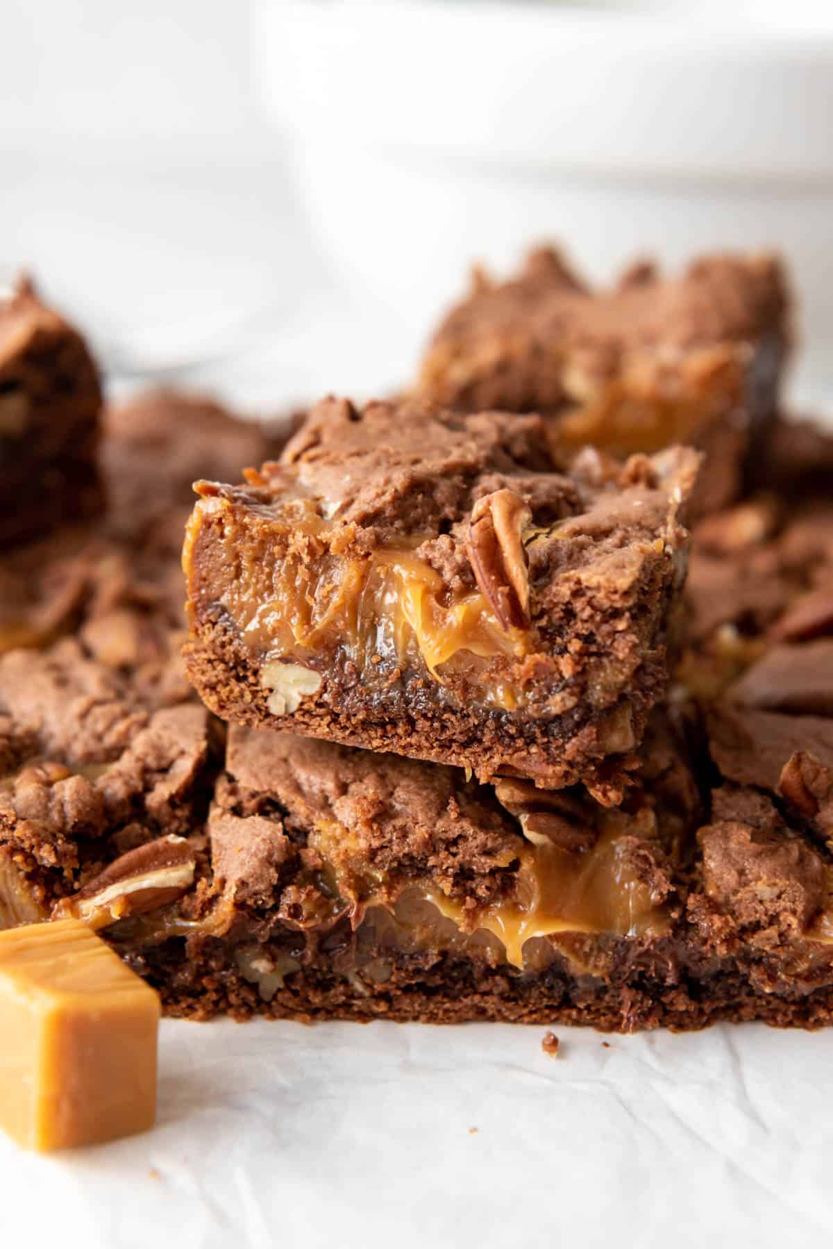 Turtle brownies stacked on top of each other.