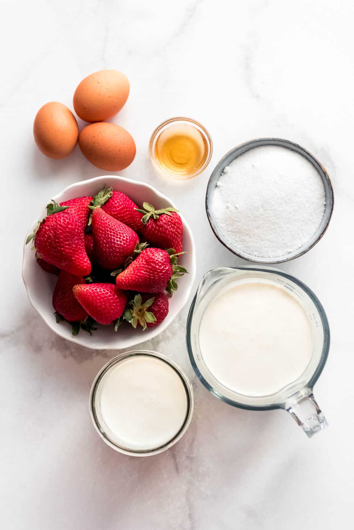 An image of ingredients for making strawberry ice cream.