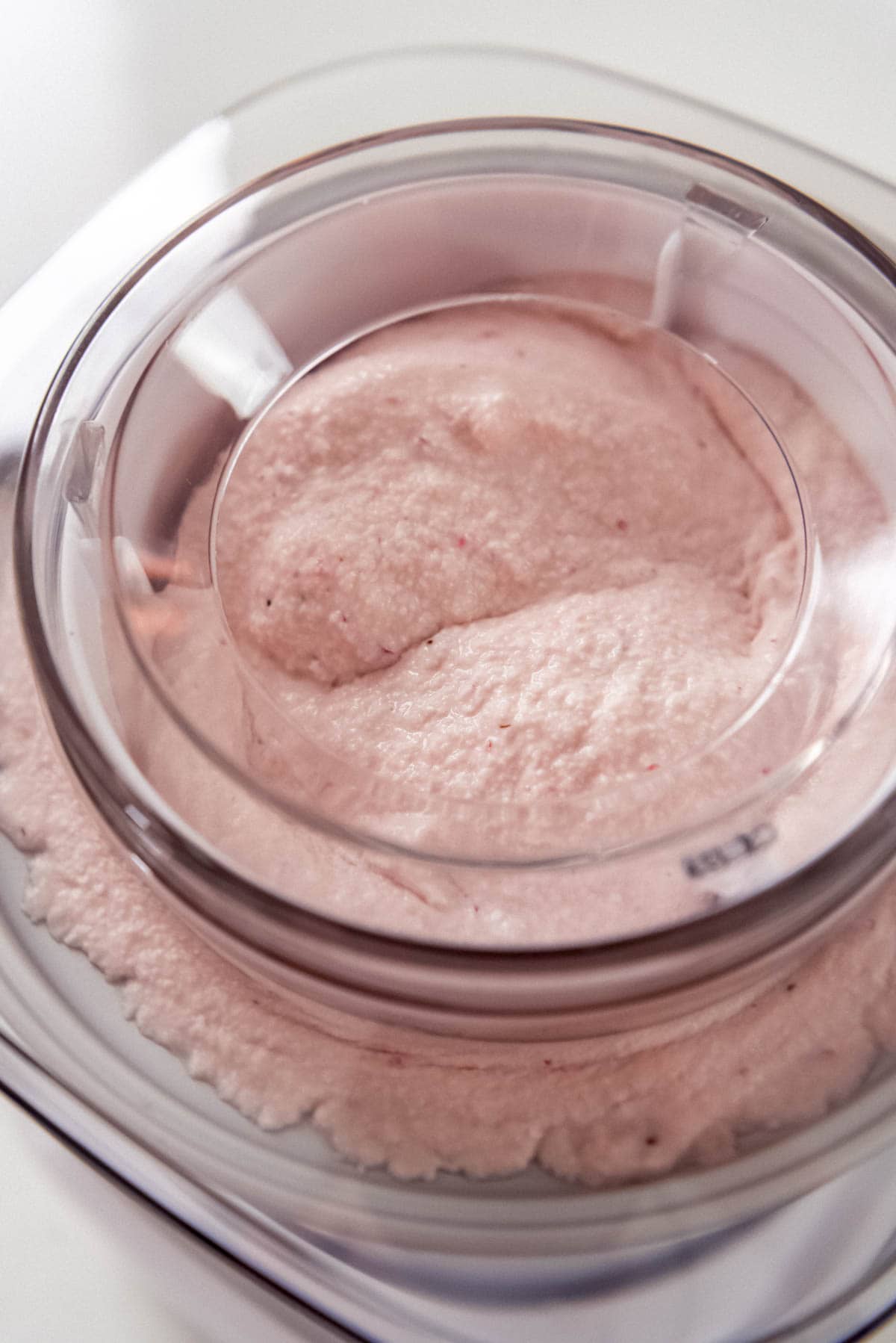 Strawberry ice cream being churned in an ice cream maker.