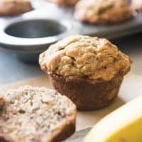 banana walnut muffins in front of a muffin tin