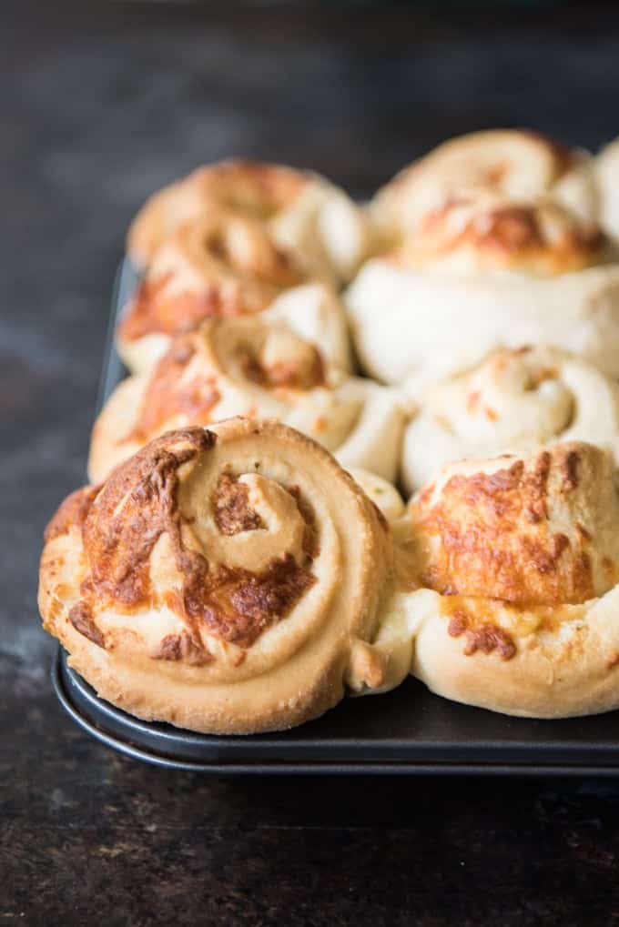 Cheesy Garlic Mozzarella Swirl Rolls in a muffin pan