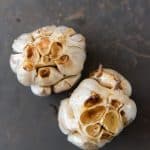 two heads of roasted garlic