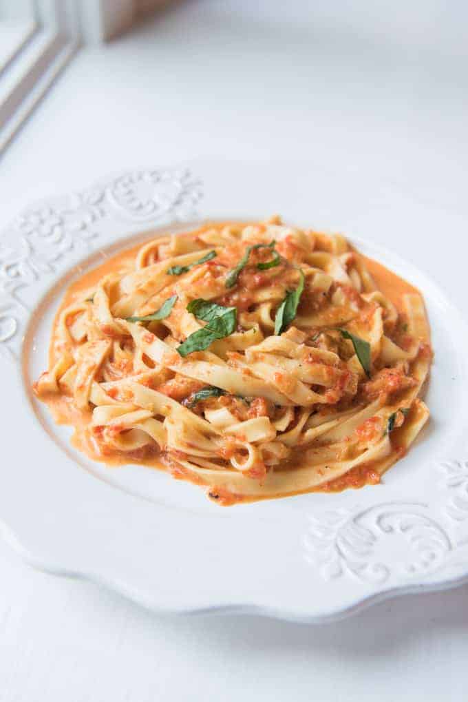roasted pepper alfredo pasta on a white plate