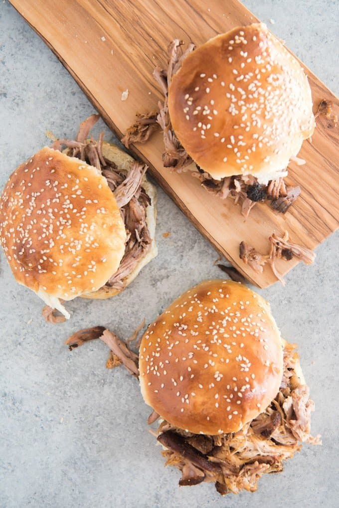 Pulled pork sandwiches on sesame seed buns.