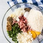 Ingredients needed to make lamb meatballs in a glass bowl