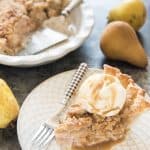 Dutch Pear & Nutmeg Pie on a plate with a fork and topped with a scoop of ice cream