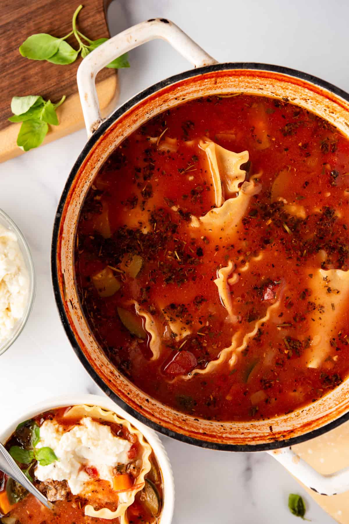 An overhead image of a large pot of lasagna soup.