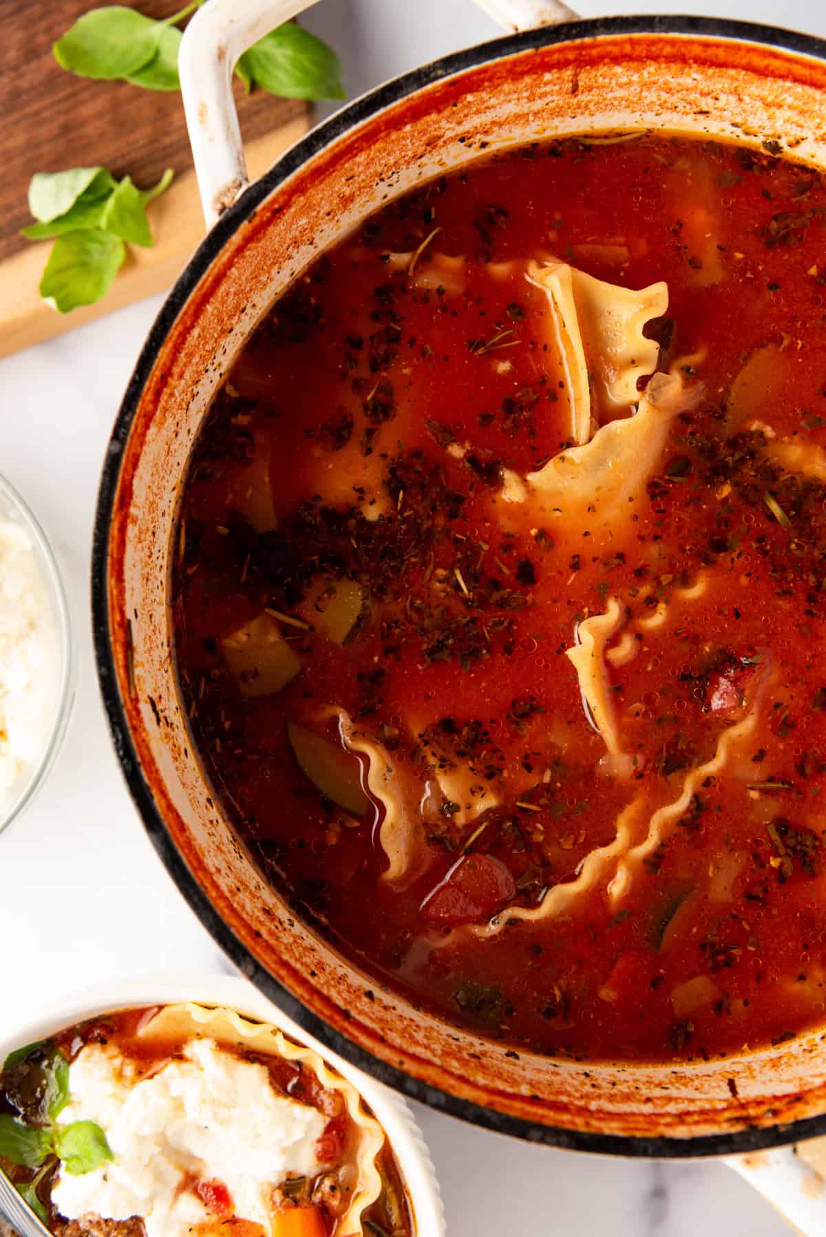 Lasagna noodles in a large pot of soup.