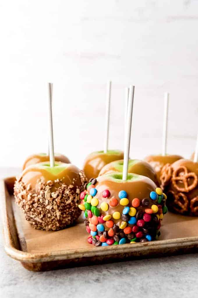 An image of homemade gourmet caramel apples covered in fun toppings.