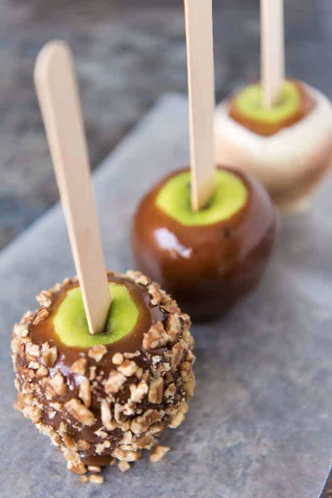 Gourmet Homemade Caramel Apples are so easy and fun to make! When the sweet, buttery caramel gets paired with crisp, tart apples, and then topped with as many crunchy, chewy, nutty or crispy toppings as you want, you will have confection perfection!