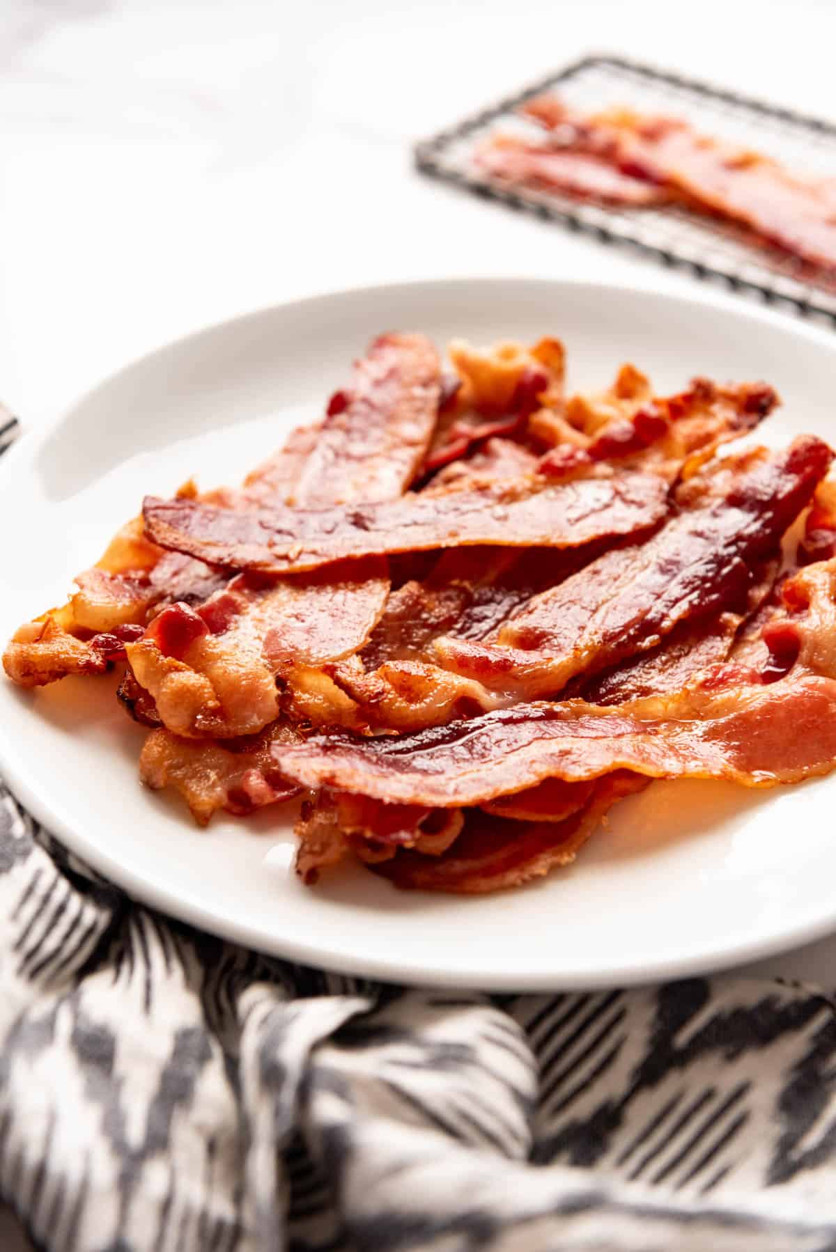 Crispy bacon on a white plate.