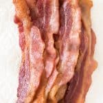 Oven baked bacon for a crowd is the key to success for a stress-free holiday breakfast, brunch with friends, or even when you need to cook up a whole package of bacon for add-ins to other dishes, salads or sandwiches. It's less hassle and mess to make bacon in the oven and your bacon will turn out perfect every time!