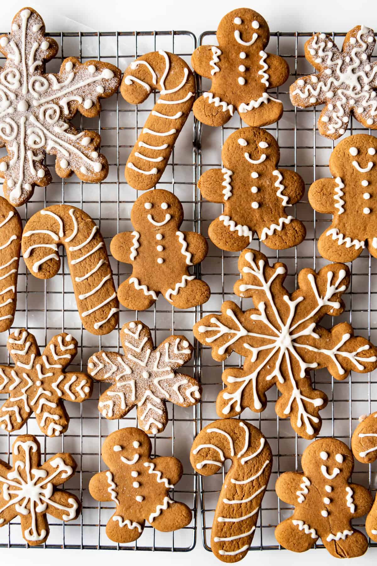 Decorated gingerbread cookies on a wire cooling rack.