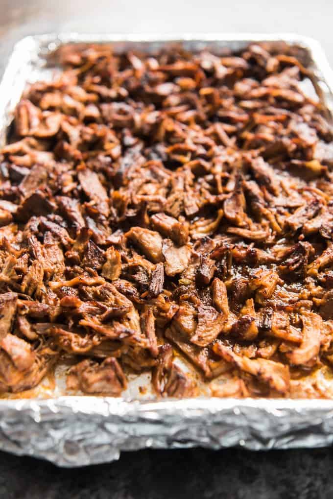 a foil lined baking sheet with shredded pork on it
