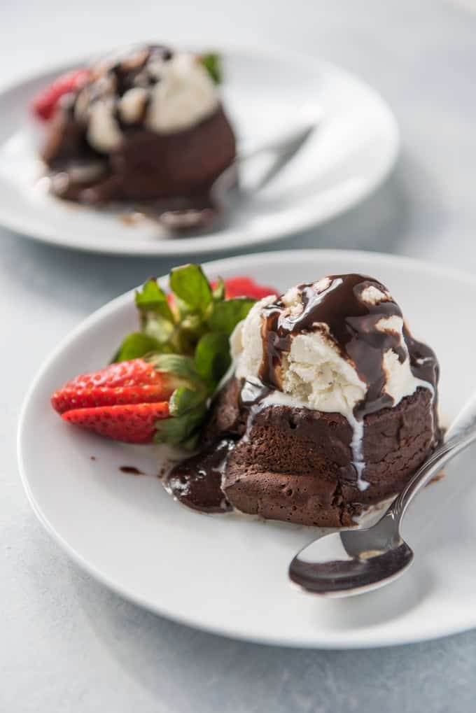 These rich, delicious Chocolate Molten Lava Cakes are sort of like a cross between a soufflé and a flourless chocolate cake, except way easier. They have a deep chocolate flavor with a molten, liquid inside that oozes out once you cut into each individually plated cake.