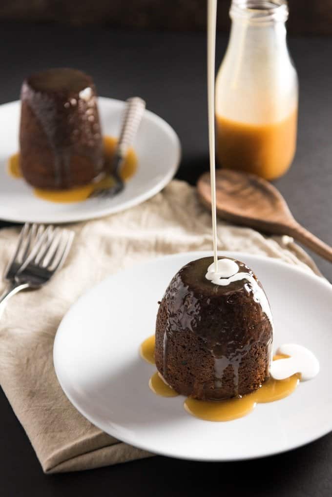 pouring white drizzle over sticky toffee pudding