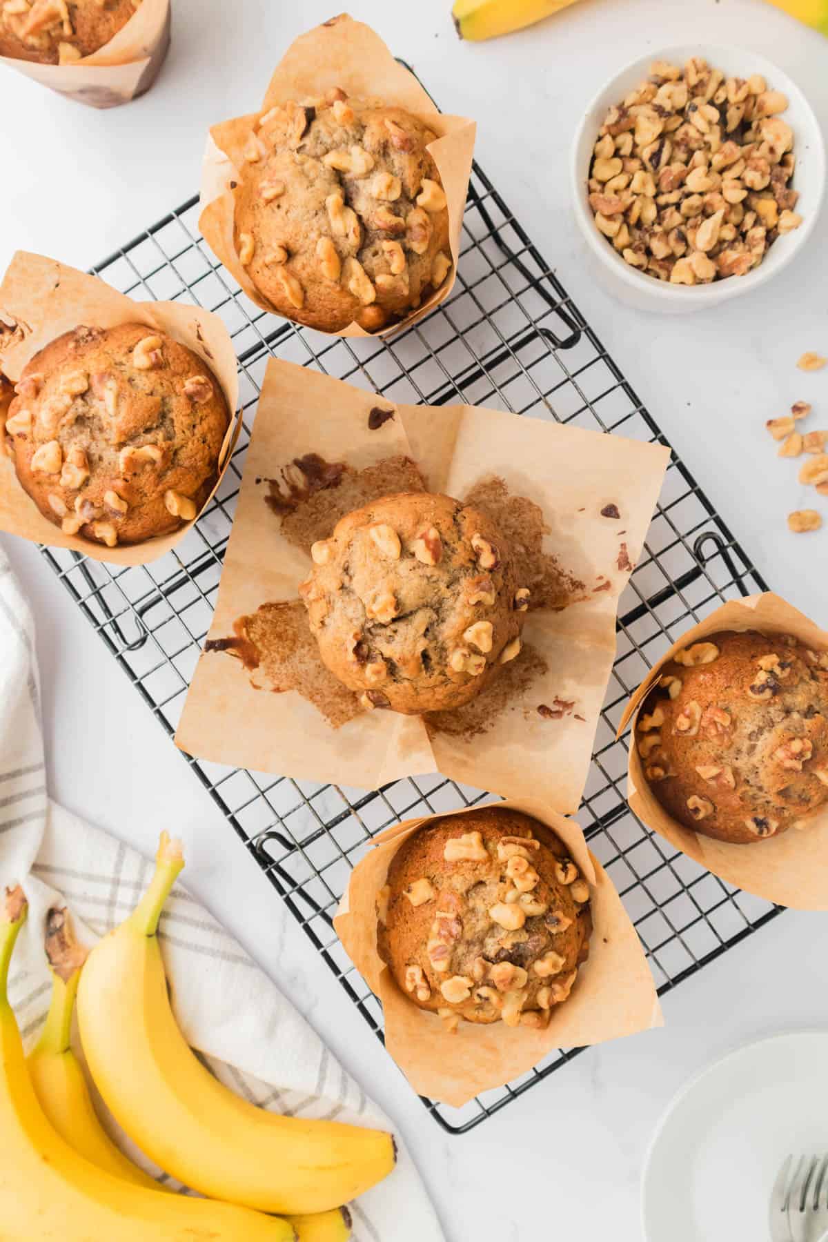 An image of banana nut muffins cooling on a wire rack. 