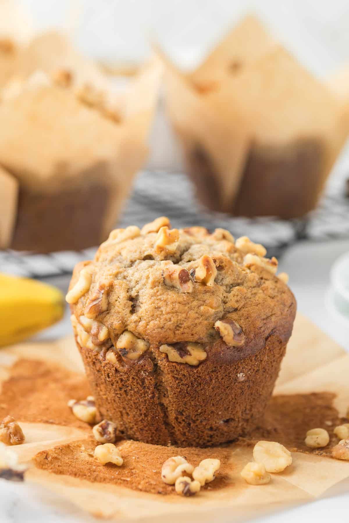 An image of a homemade banana nut muffin on a paper liner.