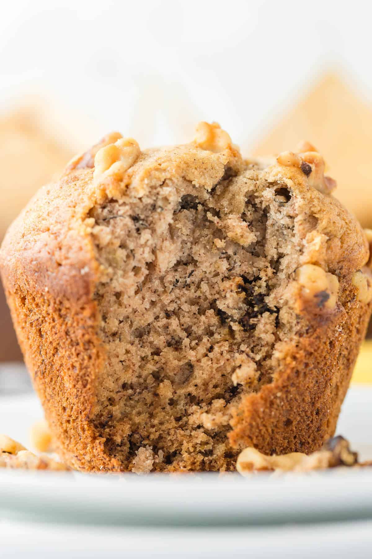 An image of a banana nut muffin with a bite taken out of it.