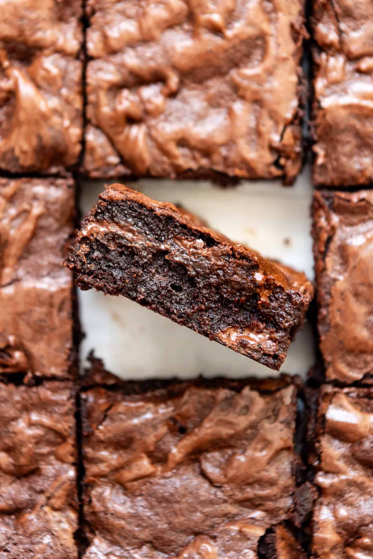 A brownie set on it's side in a pan full of more brownies.