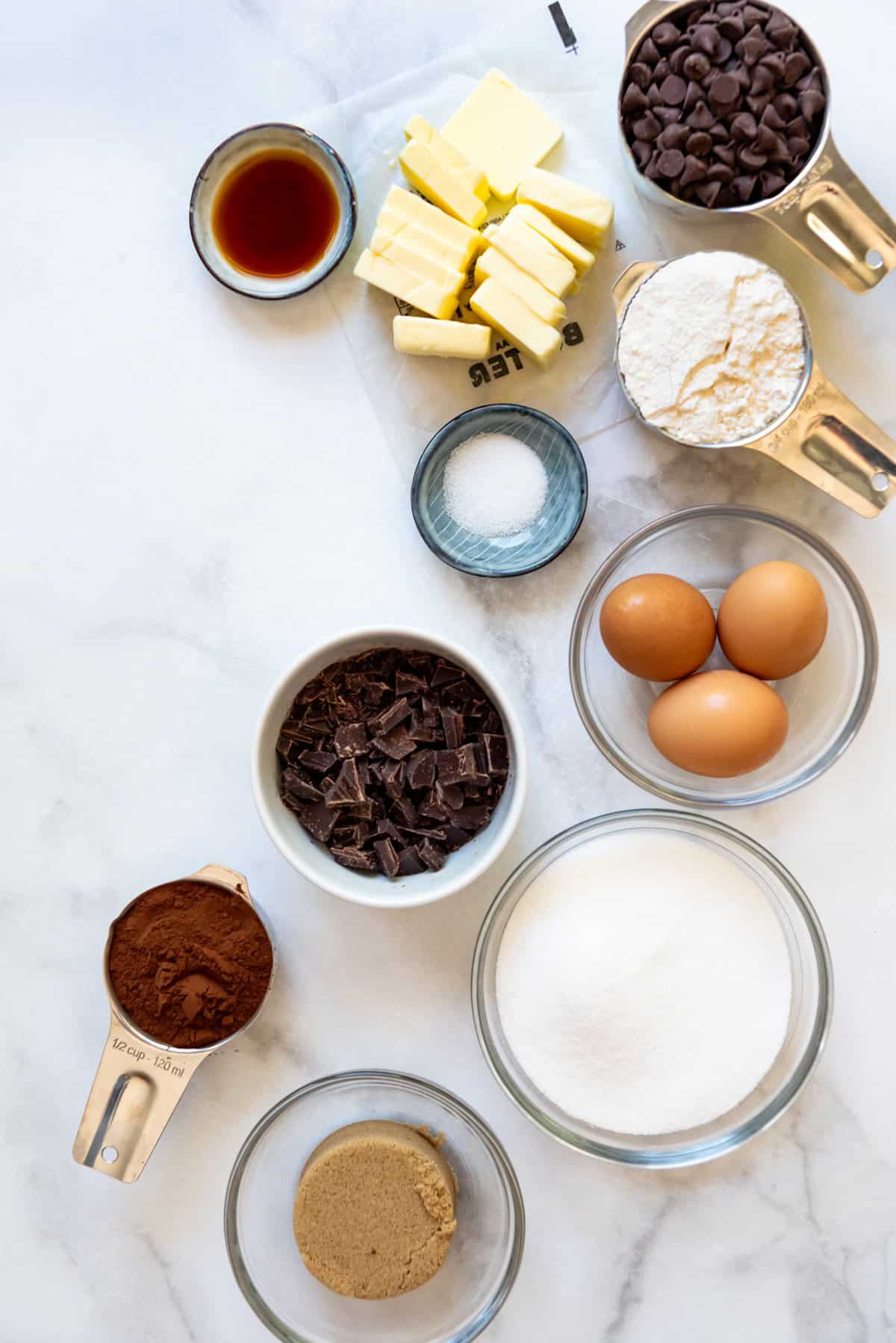 Ingredients measured into bowls and measuring cups for making brownies from scratch.