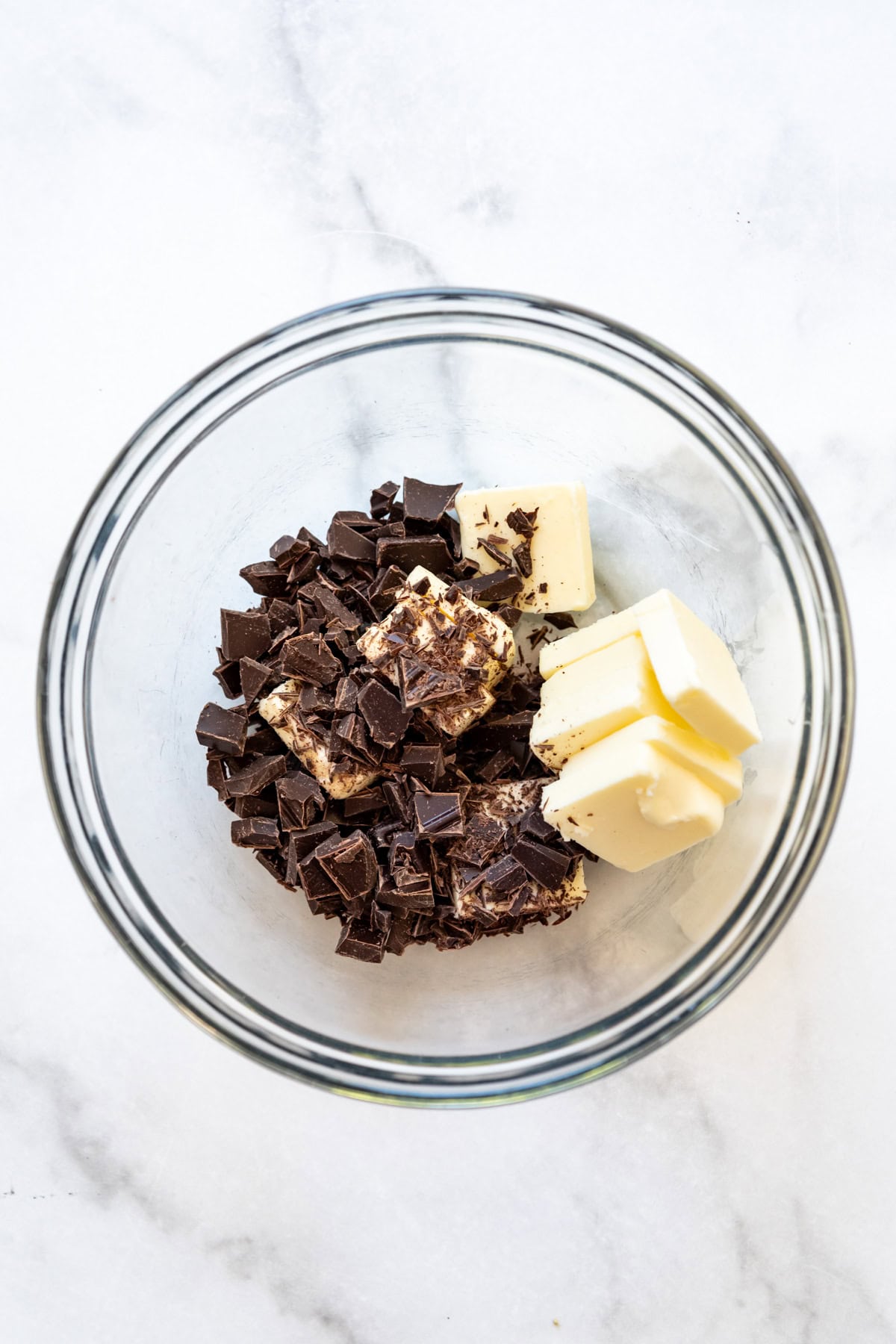 Combining chopped chocolate in a bowl with butter.